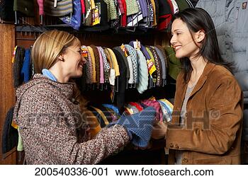 Stock Photography - two women looking 
at knit hats in 
retail store, 
smiling, side 
view. fotosearch 
- search stock 
photos, pictures, 
images, and photo 
clipart