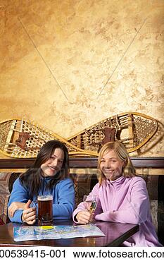 Stock Photography - two women with 
map of ski trails 
drinking beer 
and wine in pub. 
fotosearch - search 
stock photos, 
pictures, images, 
and photo clipart