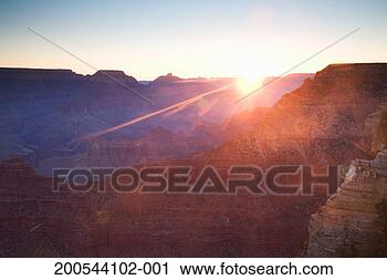 Stock Photography - usa, arizona, 
grand canyon, 
sun rising over 
canyon. fotosearch 
- search stock 
photos, pictures, 
images, and photo 
clipart