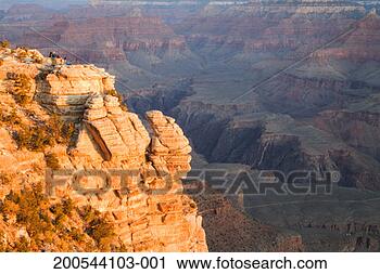 Stock Photography - usa, arizona, 
grand canyon, 
people on cliff 
in front of canyon. 
fotosearch - search 
stock photos, 
pictures, images, 
and photo clipart