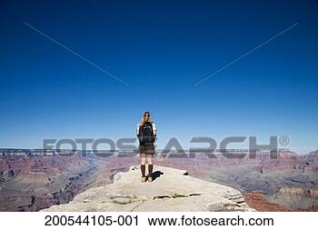 Stock Photography - usa, arizona, 
grand canyon, 
woman looking 
out over canyon, 
rear view. fotosearch 
- search stock 
photos, pictures, 
images, and photo 
clipart