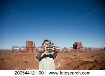 Stock Photography - usa, arizona, 
monument valley, 
woman photographing 
self. fotosearch 
- search stock 
photos, pictures, 
images, and photo 
clipart