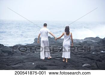 Stock Photography - usa, hawaii, big 
island, man and 
woman walking 
on beach, rear 
view. fotosearch 
- search stock 
photos, pictures, 
images, and photo 
clipart