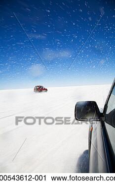 Stock Photography - vehicles driving 
on salt flat, 
(blurred motion). 
fotosearch - search 
stock photos, 
pictures, images, 
and photo clipart