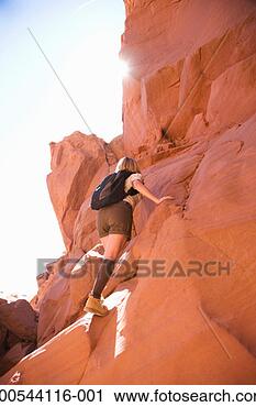 Stock Photography - woman climbing 
rocks, rear view. 
fotosearch - search 
stock photos, 
pictures, images, 
and photo clipart