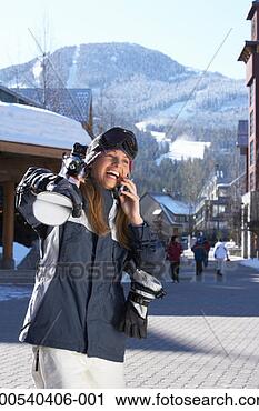 Stock Photography - woman with skis 
talking on cell 
phone, laughing. 
fotosearch - search 
stock photos, 
pictures, images, 
and photo clipart