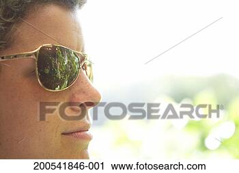 Stock Photography - woman wearing 
sunglasses, side 
view. fotosearch 
- search stock 
photos, pictures, 
images, and photo 
clipart