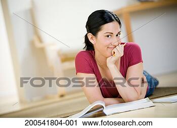 Stock Photography - young female college 
student studying 
on floor, portrait. 
fotosearch - search 
stock photos, 
pictures, images, 
and photo clipart