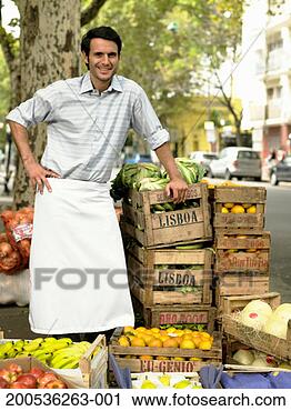 Stock Photography - young man at market 
stall on street, 
smiling, portrait. 
fotosearch - search 
stock photos, 
pictures, images, 
and photo clipart