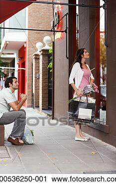 Stock Photography - young man watching 
woman window shop. 
fotosearch - search 
stock photos, 
pictures, images, 
and photo clipart