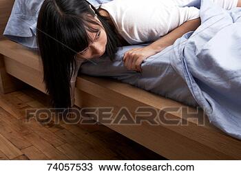 Stock Photo - young woman lying 
on bed, checking 
under it, head 
and shoulders. 
fotosearch - search 
stock photos, 
pictures, images, 
and photo clipart