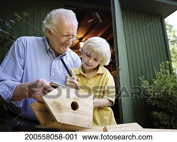 Stock Photography - grandfather making 
wooden bird box 
with grandson 
(6-7) outdoors. 
fotosearch - search 
stock photos, 
pictures, images, 
and photo clipart