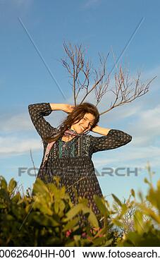 Stock Photography - portrait of teenage 
girl (16-17) outdoors, 
 holding branches 
as. fotosearch 
- search stock 
photos, pictures, 
images, and photo 
clipart