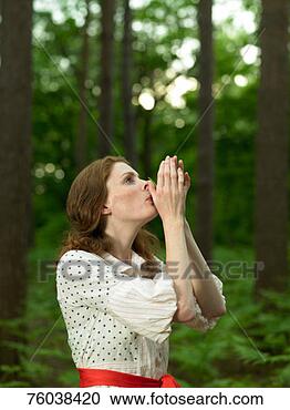 Stock Photography - woman in forest, 
holding blade 
of grass to lips 
and blowing. fotosearch 
- search stock 
photos, pictures, 
images, and photo 
clipart