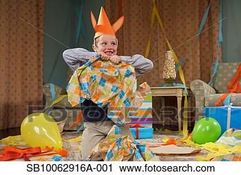 Stock Photography - young boy (6-7) 
wearing party 
hat, making mess 
in room after 
party. fotosearch 
- search stock 
photos, pictures, 
images, and photo 
clipart