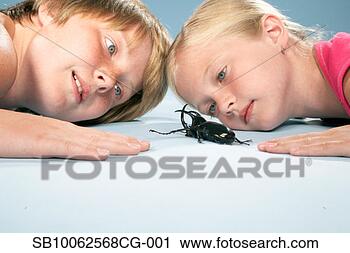 Stock Photography - girl and boy (8-11) 
lying down head 
to head and looking 
at large. fotosearch 
- search stock 
photos, pictures, 
images, and photo 
clipart