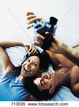 Stock Image - couple using a 
digital video 
camera to record 
themselves. fotosearch 
- search stock 
photos, pictures, 
images, and photo 
clipart