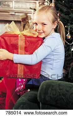 Stock Photo - portrait of a 
girl holding her 
christmas present. 
fotosearch - search 
stock photos, 
pictures, images, 
and photo clipart