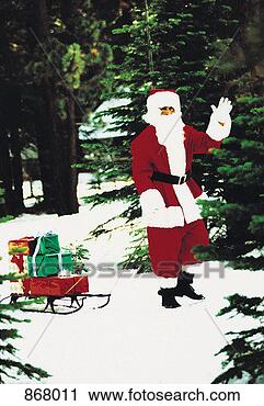 Stock Photography - santa claus pulling 
a sled of gifts 
through the snow. 
fotosearch - search 
stock photos, 
pictures, images, 
and photo clipart