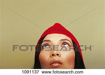 Picture - portrait of a 
young woman looking 
upwards and wearing 
a woollen hat. 
fotosearch - search 
stock photos, 
pictures, images, 
and photo clipart