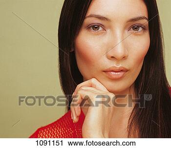 Stock Photography - portrait of a 
young woman with 
long,  black hair 
and her hand on 
her. fotosearch 
- search stock 
photos, pictures, 
images, and photo 
clipart