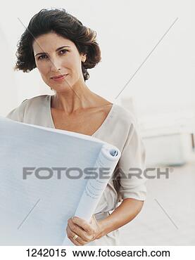 Stock Image - businesswoman 
standing and reading 
a document in 
the office. fotosearch 
- search stock 
photos, pictures, 
images, and photo 
clipart