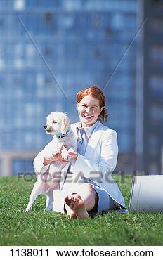 Stock Photography - portrait of a 
young,  smiling 
businesswoman 
sitting on the 
grass by a. fotosearch 
- search stock 
photos, pictures, 
images, and photo 
clipart