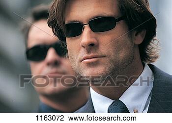 Stock Photo - portrait of a 
serious businessman 
wearing sunglasses 
and a. fotosearch 
- search stock 
photos, pictures, 
images, and photo 
clipart