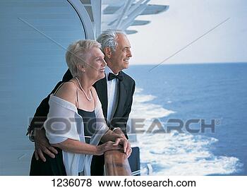 Stock Photo - side view of a 
mature couple 
looking at the 
view leaning against 
the. fotosearch 
- search stock 
photos, pictures, 
images, and photo 
clipart