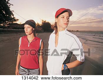 Stock Photo - two young women 
standing on a 
beach at twilight. 
fotosearch - search 
stock photos, 
pictures, images, 
and photo clipart