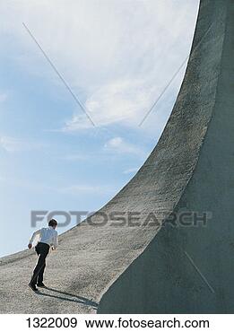Stock Photograph - one businessman 
running towards 
a steep rock incline. 
fotosearch - search 
stock photos, 
pictures, images, 
and photo clipart