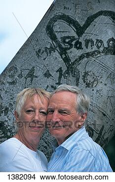 Stock Photo - portrait of a 
senior couple 
standing in front 
of a tree trunk 
with a. fotosearch 
- search stock 
photos, pictures, 
images, and photo 
clipart
