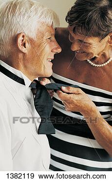 Stock Photograph - senior woman helping 
a senior man tying 
his bow tie. fotosearch 
- search stock 
photos, pictures, 
images, and photo 
clipart