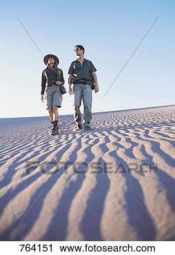 Stock Photography - couple walking 
across the desert. 
fotosearch - search 
stock photos, 
pictures, images, 
and photo clipart