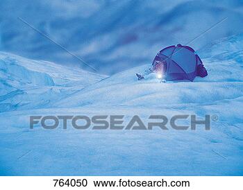 Stock Photography - man using a laptop 
and a mobile phone 
at night in snow. 
fotosearch - search 
stock photos, 
pictures, images, 
and photo clipart