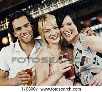 Picture - three friends 
standing in bar 
and having a drink. 
fotosearch - search 
stock photos, 
pictures, images, 
and photo clipart