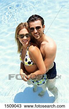 Stock Photo - elevated view 
of a young couple 
standing close 
together in a 
swimming. fotosearch 
- search stock 
photos, pictures, 
images, and photo 
clipart