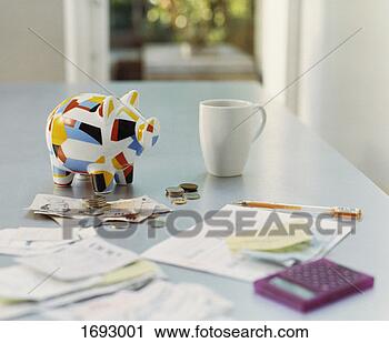Stock Photography - piggybank, british 
currency, calculator, 
receipts and a 
mug on a table. 
fotosearch - search 
stock photos, 
pictures, images, 
and photo clipart