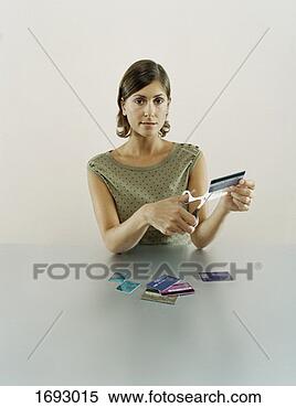 Stock Image - woman cutting 
her bank cards 
with a pair of 
scissors. fotosearch 
- search stock 
photos, pictures, 
images, and photo 
clipart