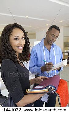 Stock Photo - woman examines 
a fabric swatch 
in an interiors 
shop,  the shop. 
fotosearch - search 
stock photos, 
pictures, images, 
and photo clipart