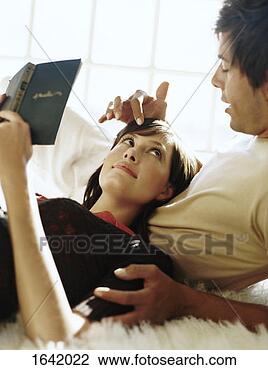 Stock Photo - woman gazing at 
a man as she relaxes 
against him. fotosearch 
- search stock 
photos, pictures, 
images, and photo 
clipart
