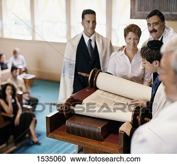 Stock Photography - young boy reads 
from the torah 
at his bar mitzvah 
in front of his. 
fotosearch - search 
stock photos, 
pictures, images, 
and photo clipart