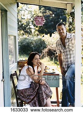 Stock Photo - couple enjoying 
a meal on the 
porch of their 
rustic home. fotosearch 
- search stock 
photos, pictures, 
images, and photo 
clipart