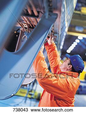 Stock Photo - worker checking 
train in factory. 
fotosearch - search 
stock photos, 
pictures, images, 
and photo clipart