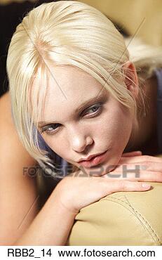 Stock Photo - a closeup shot 
of a young blonde 
caucasian girl 
leaning on taupe. 
fotosearch - search 
stock photos, 
pictures, images, 
and photo clipart