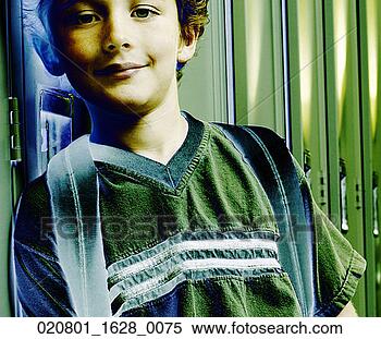 Stock Image - young boy standing 
by a locker. fotosearch 
- search stock 
photos, pictures, 
images, and photo 
clipart