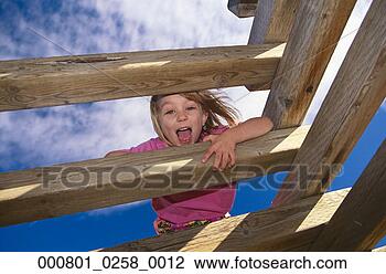 Stock Photo - young girl on 
play structure 
taunting us from 
above. fotosearch 
- search stock 
photos, pictures, 
images, and photo 
clipart