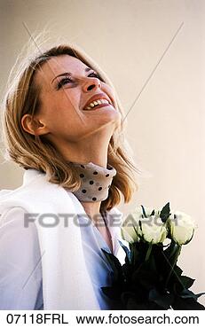 Stock Photo - woman with bouquet 
of roses looking 
up. fotosearch 
- search stock 
photos, pictures, 
images, and photo 
clipart