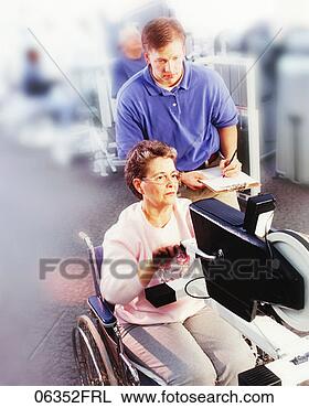 Stock Photo - woman in wheelchair 
exercising upper 
body,  technician 
monitoring. fotosearch 
- search stock 
photos, pictures, 
images, and photo 
clipart