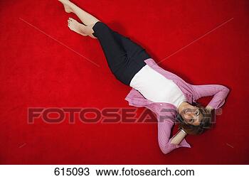 Stock Photo - woman relaxes 
by laying on floor. 
fotosearch - search 
stock photos, 
pictures, images, 
and photo clipart